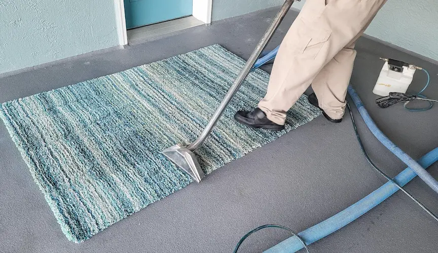 Man has small business cleaning carpets by shampooing and then steam cleaning.
